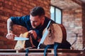 Chef cook cutting exclusive jerky meat on table in a kitchen with loft interior. Royalty Free Stock Photo