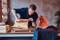 Chef cook cutting exclusive jerky meat on table in a kitchen with loft interior. Royalty Free Stock Photo