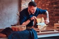 Chef cook cutting exclusive jerky meat on table in a kitchen with loft interior. Royalty Free Stock Photo