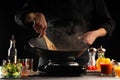 Chef cook fried in a pan meat with vegetables, on the background of fresh vegetables, culinary recipes. Restaurant business, hotel