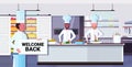 Chef cook holding welcome back sign board coronavirus quarantine is ending victory over covid-19 concept