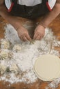 Chef cook making khinkali on wooden table. Process preparation georgian meal.