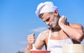 Chef cook preparing dough for baking. Cookery concept. Cook or chef with muscular shoulders and chest mixing flour