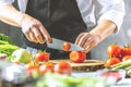 Chef prepares vegetables to cook in the restaurant kitchen Royalty Free Stock Photo