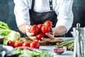 Chef prepares vegetables to cook in the restaurant kitchen Royalty Free Stock Photo