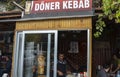 Chef or cook selling traditional turkish doner kebab. Street food market. Fast food