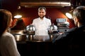 Chef cook serving dishes to the couple