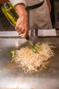 Chef cooking bean sprout with sauce