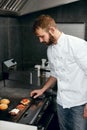 Chef Cooking Burgers in Kitchen Royalty Free Stock Photo