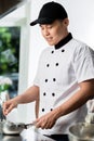 Chef cooking in a commercial kitchen Royalty Free Stock Photo