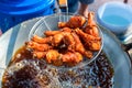 Chef cooking crispy fried chicken in oil hot pan on street food market in Thailand. Royalty Free Stock Photo