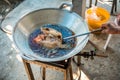 Chef cooking deep-fried fish in the big pan to Chinese banquet food preparation. fat from trans-fat concept. disease from choleste