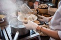 Chef cooking noodle with shrimp and fish ball in local restaurant