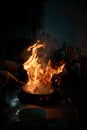 Chef cooking and doing flambe on food Royalty Free Stock Photo