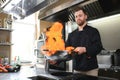 Chef cooking and doing flambe on food in restaurant kitchen Royalty Free Stock Photo