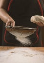 Chef cooking dough to bake a cake on a wooden table. Royalty Free Stock Photo