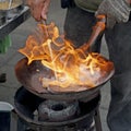 Chef cooking with fire in frying pan Royalty Free Stock Photo