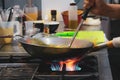 Chef cooking with flame in a frying pan on a kitchen stove, Chef Royalty Free Stock Photo