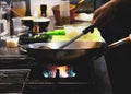 Chef cooking food in the kitchen, stir fried vegetables in the pan Royalty Free Stock Photo