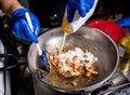 Chef cooking pasta with mussels in pan. Italian style cuisine. Restaurant. Royalty Free Stock Photo