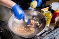 Chef cooking pasta with mussels in pan. Italian style cuisine. Restaurant. Royalty Free Stock Photo