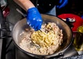 Chef cooking pasta with mussels in pan. Italian style cuisine. Restaurant. Royalty Free Stock Photo