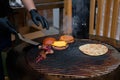 Chef cooking pieces of meat, burgers bums, cutlet and pita on grill - close up Royalty Free Stock Photo