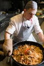 Chef cooking plov traditional uzbek rice meal