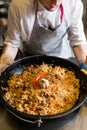 Chef cooking plov traditional uzbek rice meal