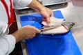 Chef cooking raw fish on kitchen, Process of cooking fish Royalty Free Stock Photo