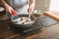 Chef cooking sea bass fish fillet on a frying pan Royalty Free Stock Photo