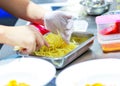 Chef cooking spaghetti in the kitchen, Chef putting Spaghetti to the plate Royalty Free Stock Photo