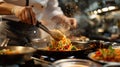 Chef cooking spaghetti in restaurant kitchen, closeup. Chef decorating dish. Royalty Free Stock Photo