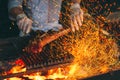 Chef Cooking steak. Cook turns the meat on the fire.