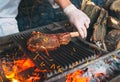 Chef Cooking steak. Cook turns the meat on the fire.