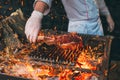 Chef Cooking steak. Cook turns the meat on the fire.