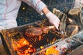 Chef Cooking steak. Cook turns the meat on the fire.