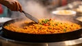 Chef cooking steaming fried rice in a large pan with vegetables Royalty Free Stock Photo