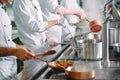 Chef cooking vegetables in wok pan. Shallow dof. Royalty Free Stock Photo