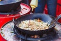 Chef cooks Chinese noodle wok at street food festival