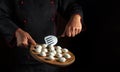 The chef cooks dumplings in the kitchen of the hotel or restaurant. Free space for advertising