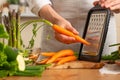 The chef cooks fresh carrots for salad. The concept of losing healthy and wholesome food, detox, vegan eating, diet, cooking. Slow