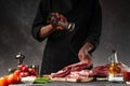 Chef cooks fresh pork or beef ribs. Against the background of vegetables.Sole, freezing motion Royalty Free Stock Photo