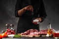 Chef cooks fresh pork or beef ribs. Against the background of vegetables.Sole, freezing motion Royalty Free Stock Photo