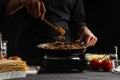 The chef cooks, fry ground beef in a pan for cooking pasta on flotsky, lasagna and many dishes. Cooking and home recipes