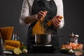 Chef cooks Italian pasta, on the background of vegetables and seafood, shrimp and vegetables. Cooking and recipe book, cooking Royalty Free Stock Photo