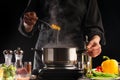 Chef cooks Italian pasta, with sauce on a background with vegetables. Ingredients for cooking. Restaurant business, cooking, tasty Royalty Free Stock Photo