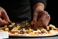 Chef cooks pizza, puts olives on the background with ingredients. Recipe book, menu, home cooking, pizzeria. Macro, close-up Royalty Free Stock Photo