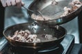 The chef cooks the small octopus on a metal frying pan Royalty Free Stock Photo