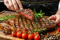 Chef crafting grilled steak in butter lemon or cajun sauce with herbs for fine dining experience